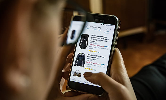 Person browsing an online store on a smartphone, highlighting the rise of mobile eCommerce shopping.